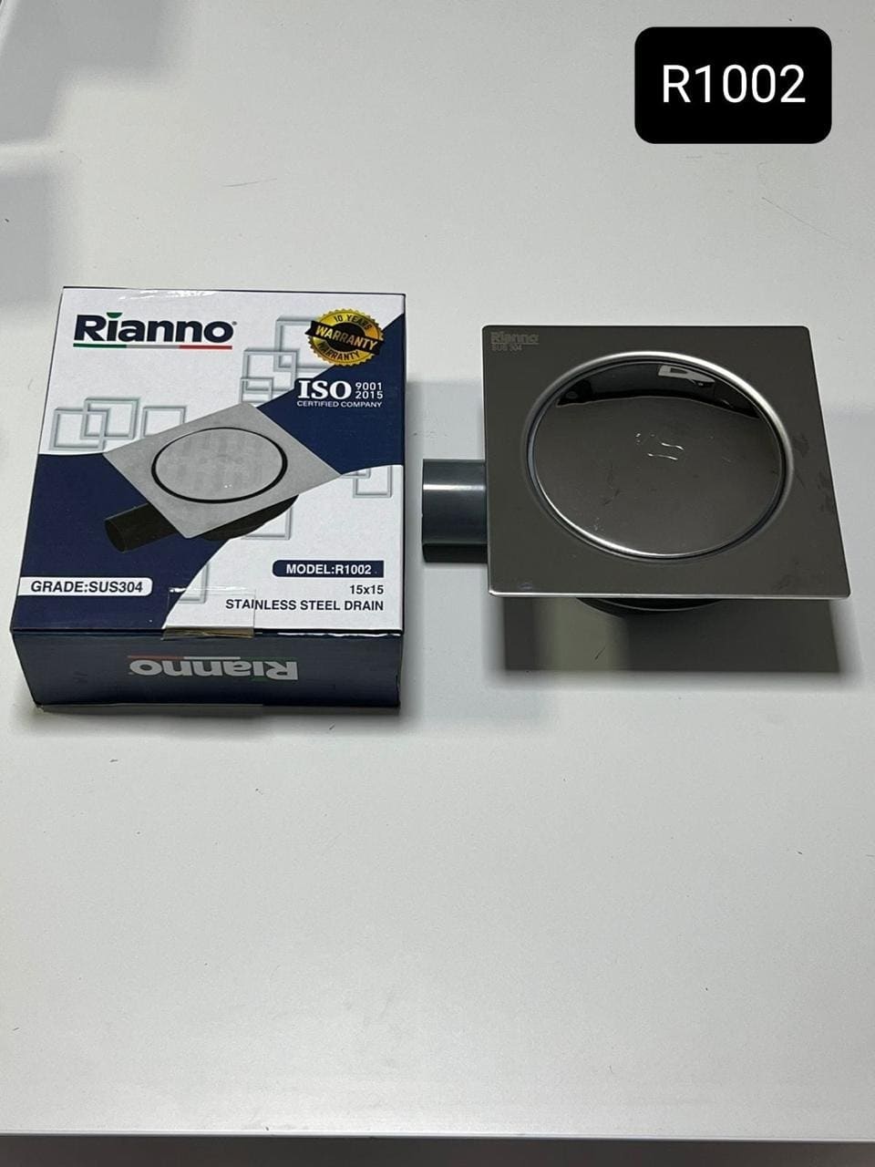 Siphon de Sol Carré à Poussoir en Inox Rianno – R1002 – Grade SUS304 (15x15 cm)